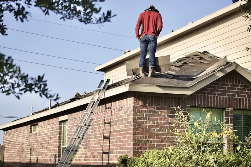 Professional roofer working on a residential roof in Sandy Ridge